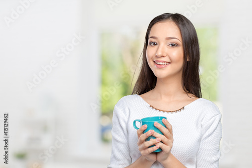 Portrait of young woman having coffee