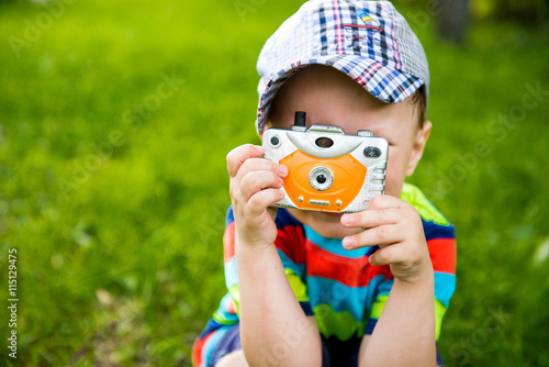 little boy photographs the camera