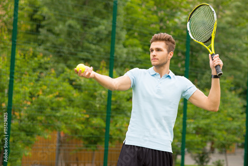 Confident male athlete playing tennis © Yakobchuk Olena