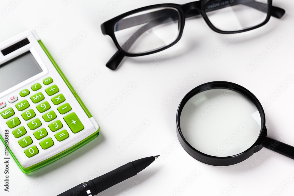 Calculator with a magnifying glass on a white background Calculator with a magnifying glass on a white background