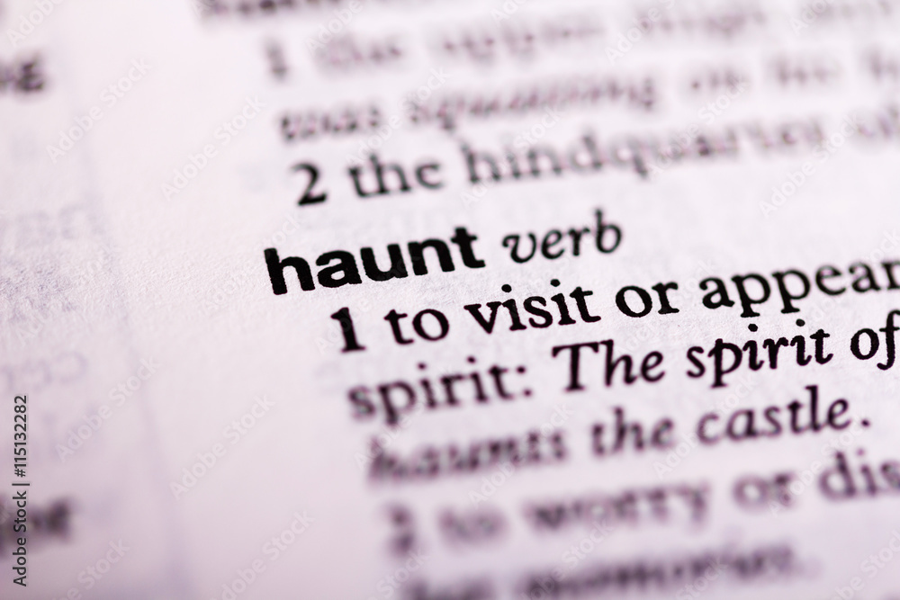 Close up of the dictionary definition of haunt Close up of the dictionary definition of haunt