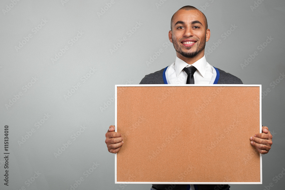 black man holding a cork board black man holding a cork board