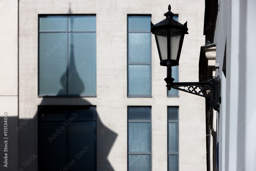 The shadow of the towers of the old house on the facade of a mod
