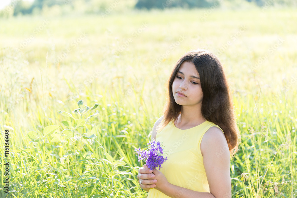 Girl with bouquet of wildflowers in summer field Girl with bouquet of wildflowers in summer field