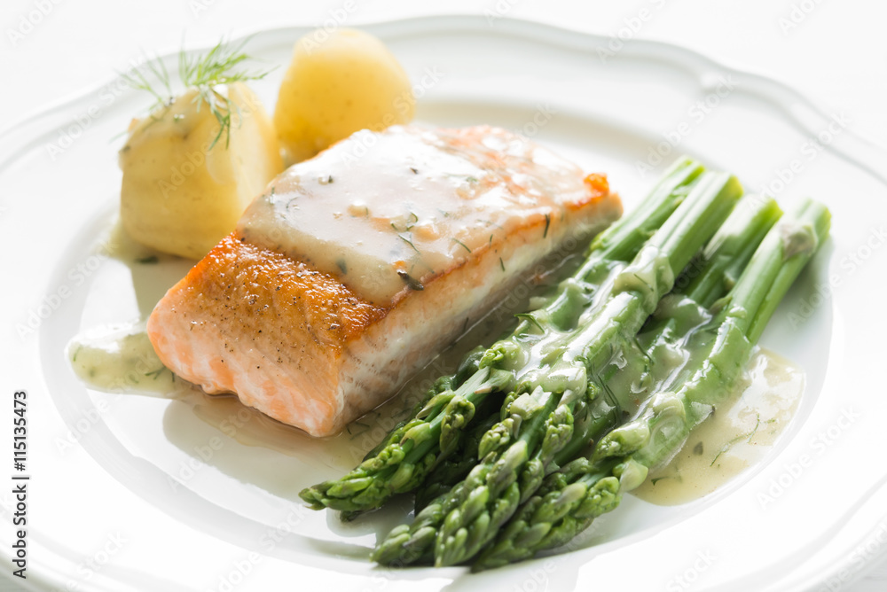 Grilled salmon with boiled potatoes and asparagus on white plate Grilled salmon with boiled potatoes and asparagus on white plate