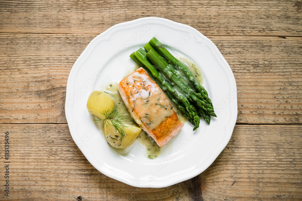 Grilled salmon with boiled potatoes and asparagus. Top view