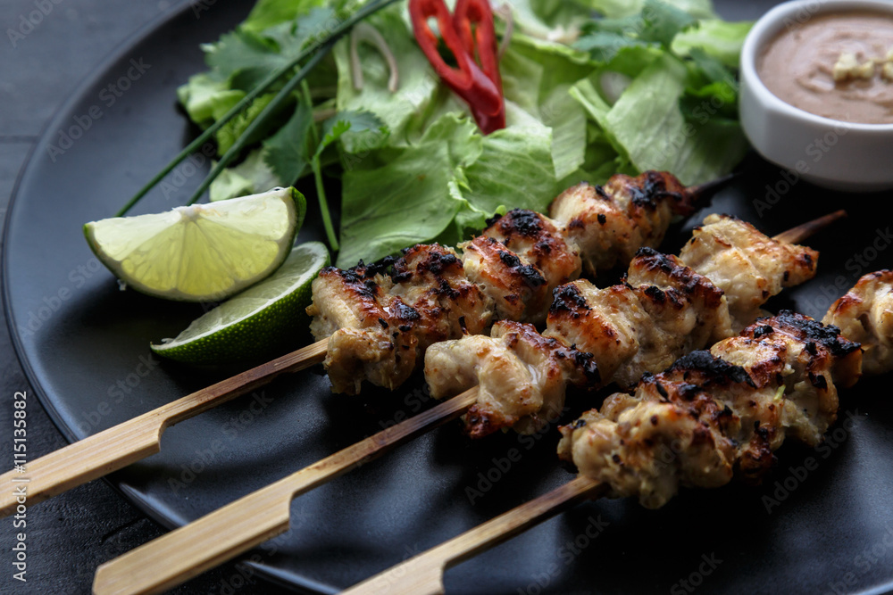chicken satay with peanut sauce, indonesian skewer food, close view