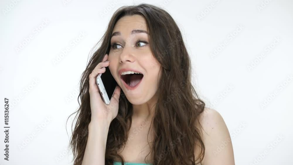Beautiful woman talking on mobile with happy smile hearing good news Beautiful woman talking on mobile with happy smile hearing good news