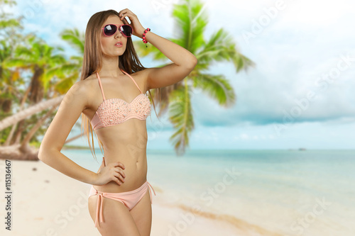 Woman in bikini and sunglasses isolated