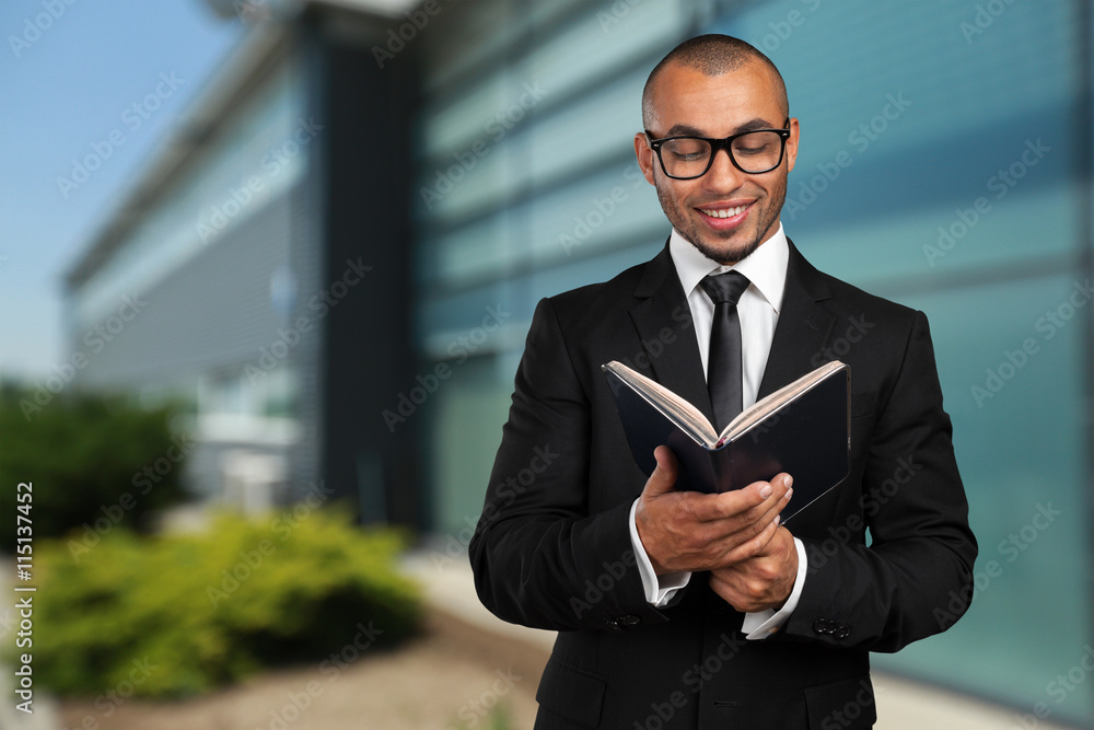 business black man holding a book business black man holding a book