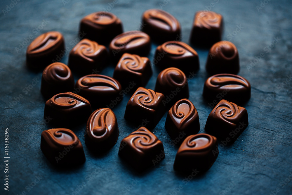 Chocolates background. Dark Chocolate Candy. Praline sweets..Low Chocolates background. Dark Chocolate Candy. Praline sweets..Low