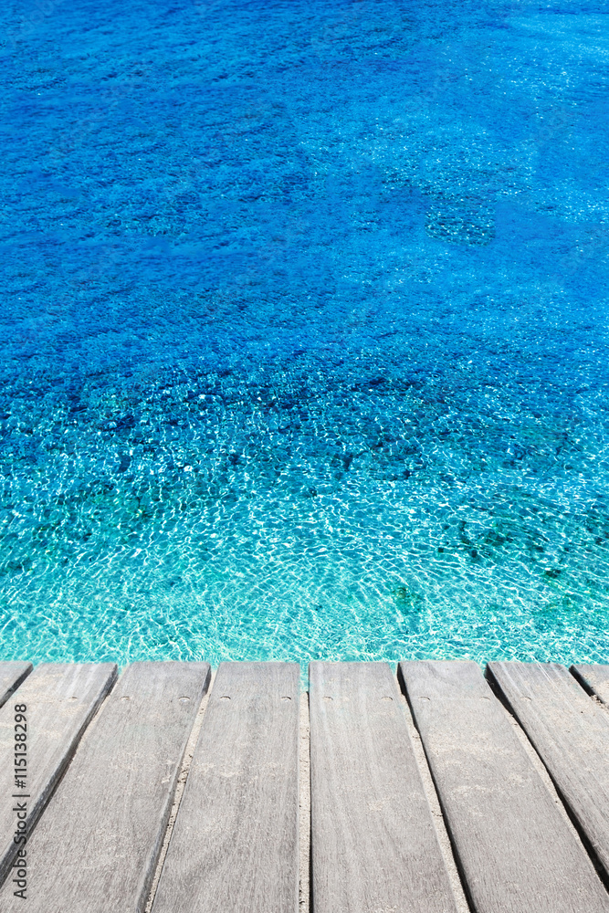 Beach and tropical sea. Blue sea water and wooden terrace.