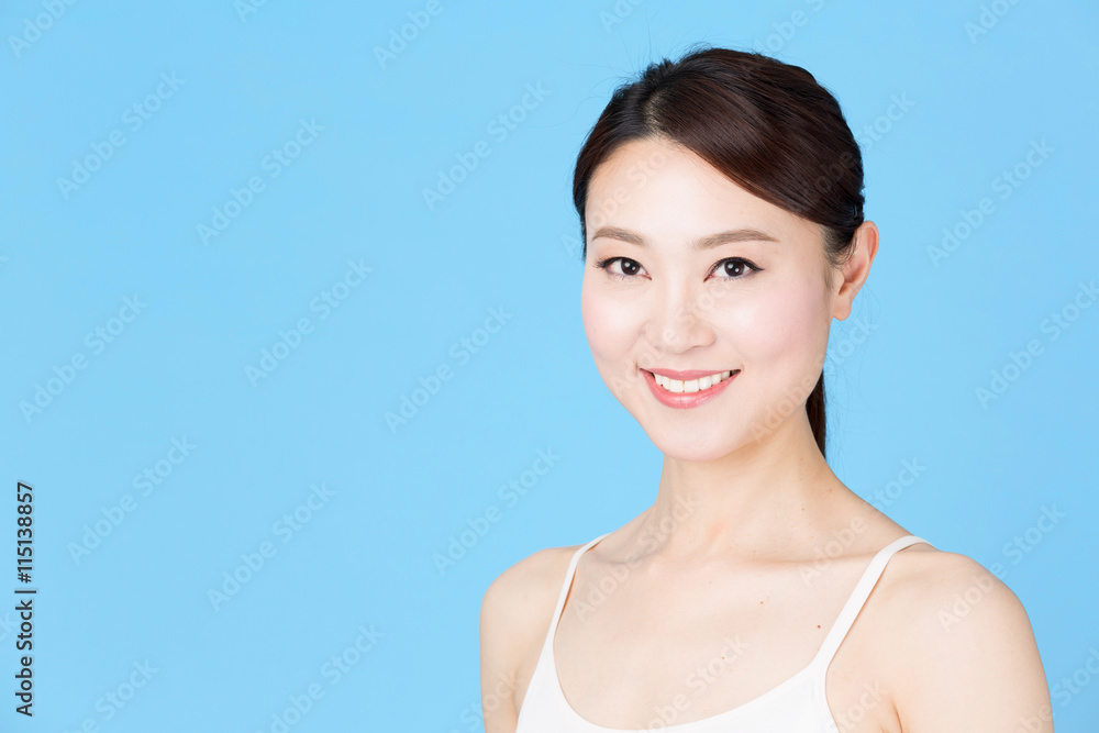attractive asian woman isolated on blue background attractive asian woman isolated on blue background