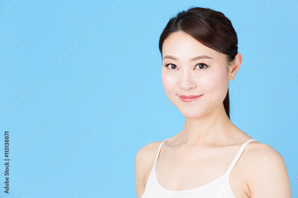 attractive asian woman isolated on blue background attractive asian woman isolated on blue background