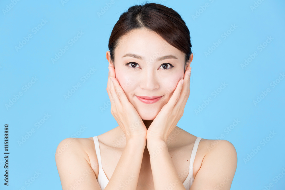 attractive asian woman isolated on blue background attractive asian woman isolated on blue background