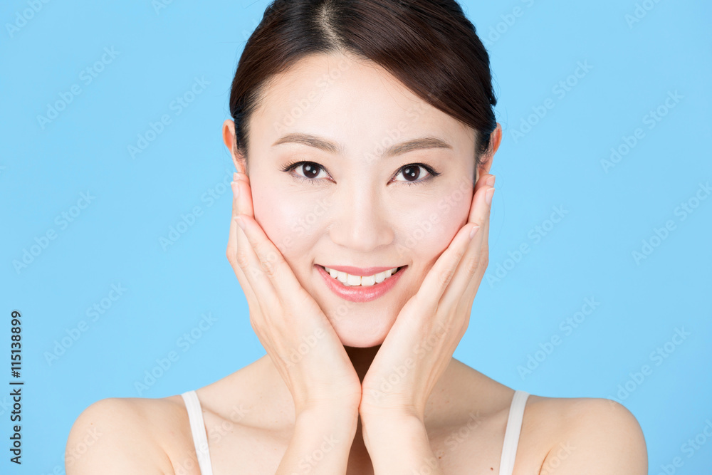 attractive asian woman isolated on blue background attractive asian woman isolated on blue background