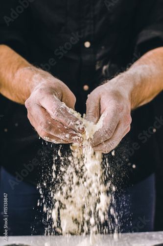 adult man hands work with flour, dark photo