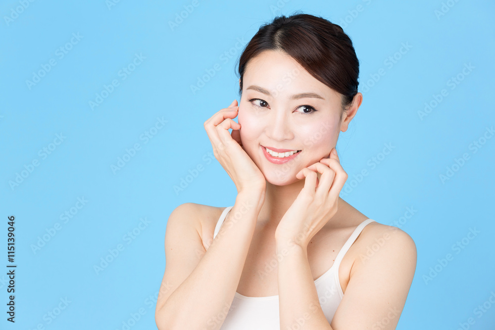 attractive asian woman isolated on blue background attractive asian woman isolated on blue background