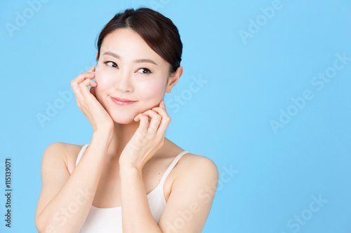 attractive asian woman isolated on blue background