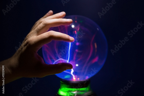 finger on the plasma ball, ball of light Tesla. photo