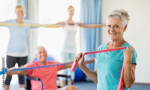 Fototapeta Naklejka Na Ścianę i Meble -  Seniors exercising with stretching bands