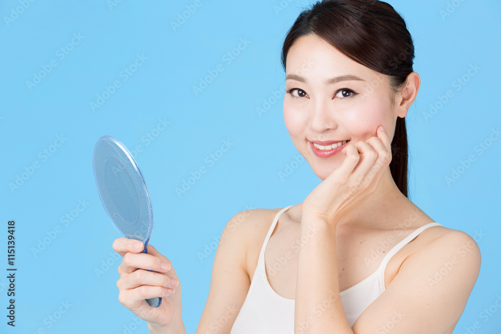 attractive asian woman isolated on blue background attractive asian woman isolated on blue background