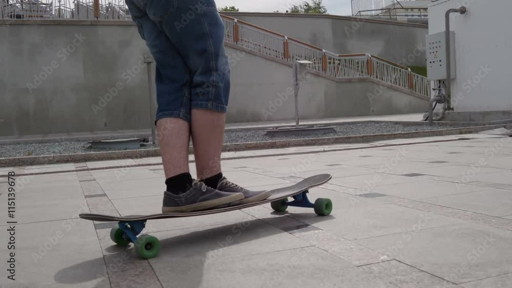 A young guy riding a longboard along the waterfront and makes tricks A young guy riding a longboard along the waterfront and makes tricks