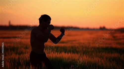 The guy is Boxing at sunset photo