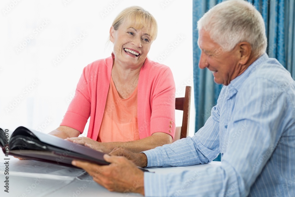Fototapeta premium Senior couple looking at photo album