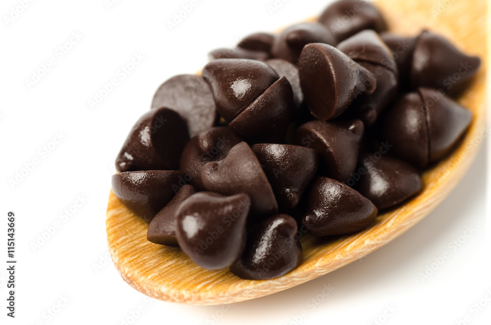 Chocolate chips on wooden spoon Chocolate chips on wooden spoon