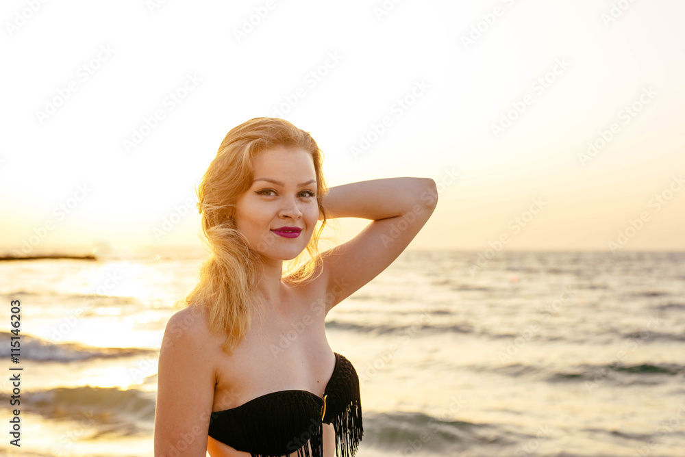 young beautiful female on beach enjoying vacation during sunset or sunrise young beautiful female on beach enjoying vacation during sunset or sunrise