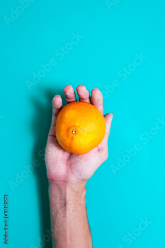 Fresh orange fruits and juice on blue table.