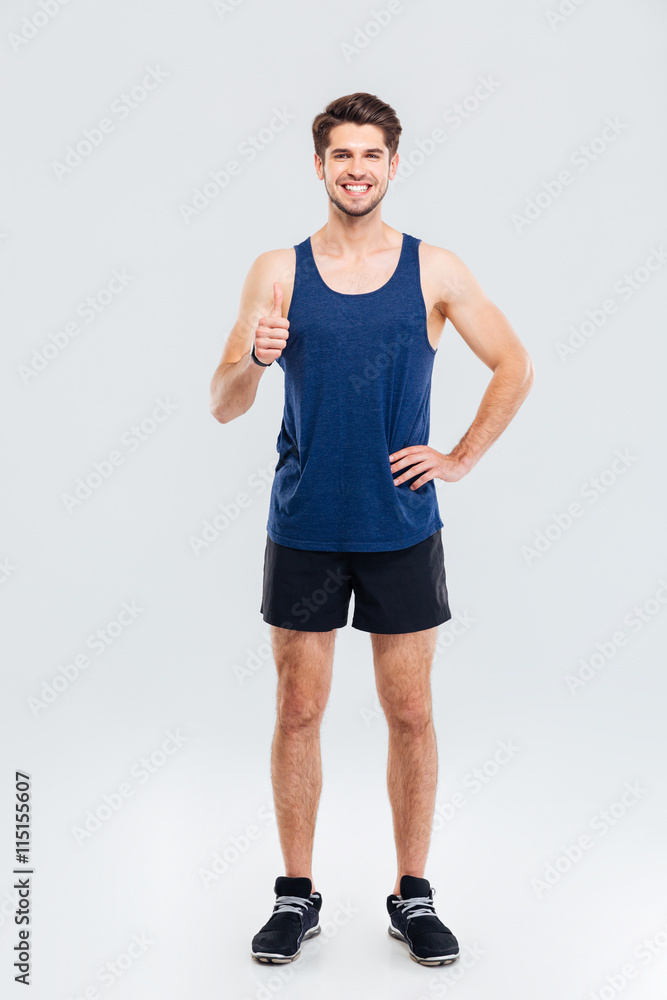 Full length portrait of a fitness man showing thumb up Full length portrait of a fitness man showing thumb up