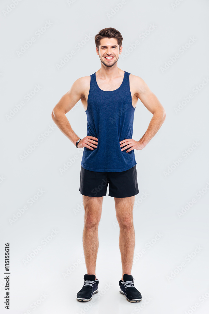 Full length portrait of sportsman standing with hands on hips Full length portrait of sportsman standing with hands on hips