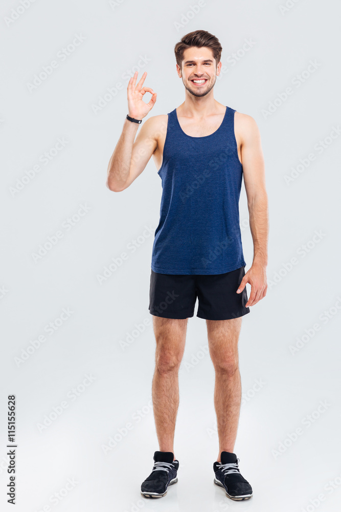 Full length portrait of a fitness man showing okay sign Full length portrait of a fitness man showing okay sign