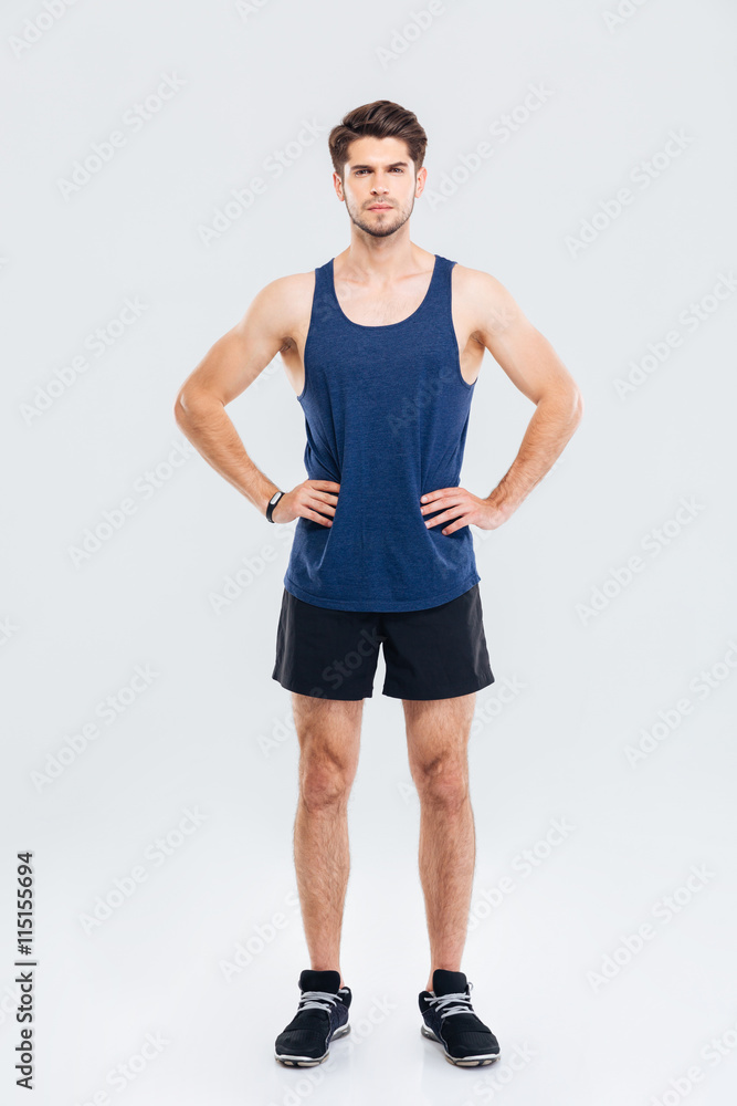 Full length portrait of sportsman standing with hands on hips Full length portrait of sportsman standing with hands on hips