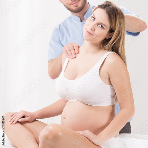 Pregnant woman and masseur