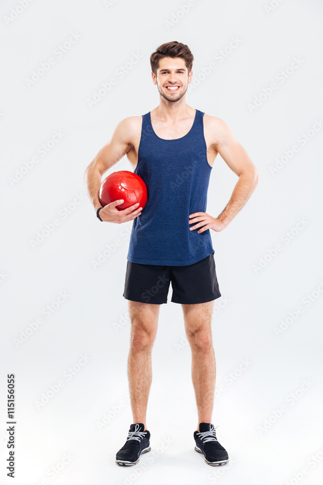 Full length portrait of a handsome sportsman with fitness ball Full length portrait of a handsome sportsman with fitness ball