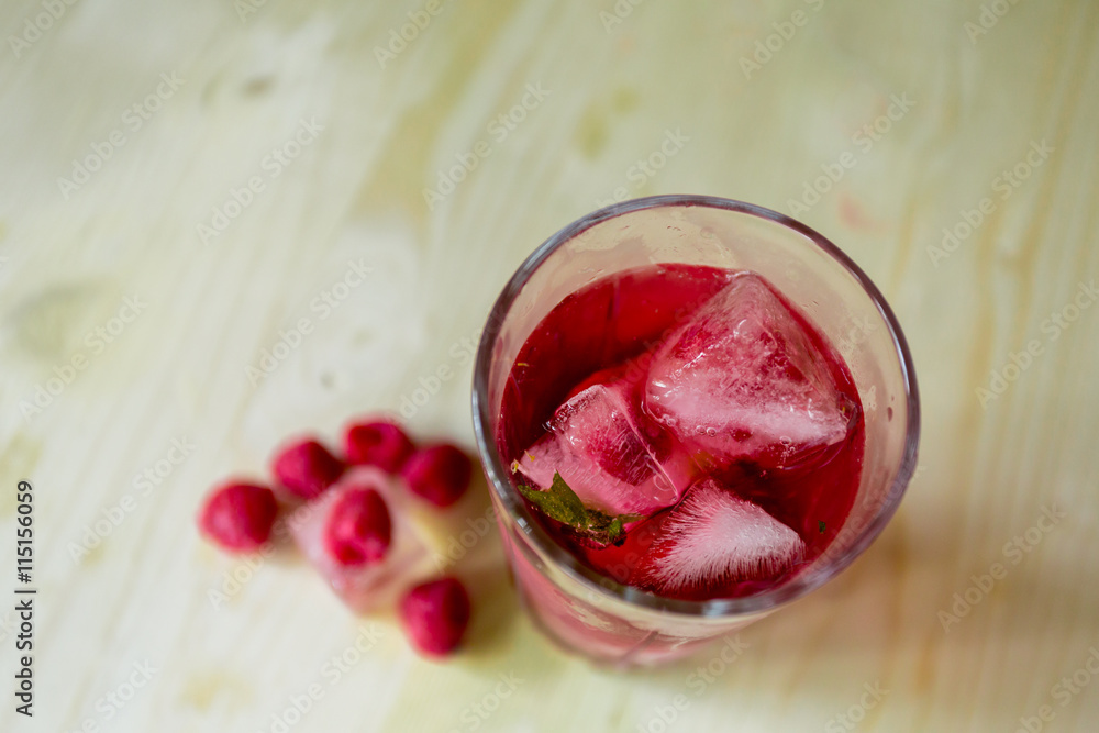 homemade refreshing summer cocktail with ice, fresh berries raspberry on wooden cutting Board homemade refreshing summer cocktail with ice, fresh berries raspberry on wooden cutting Board