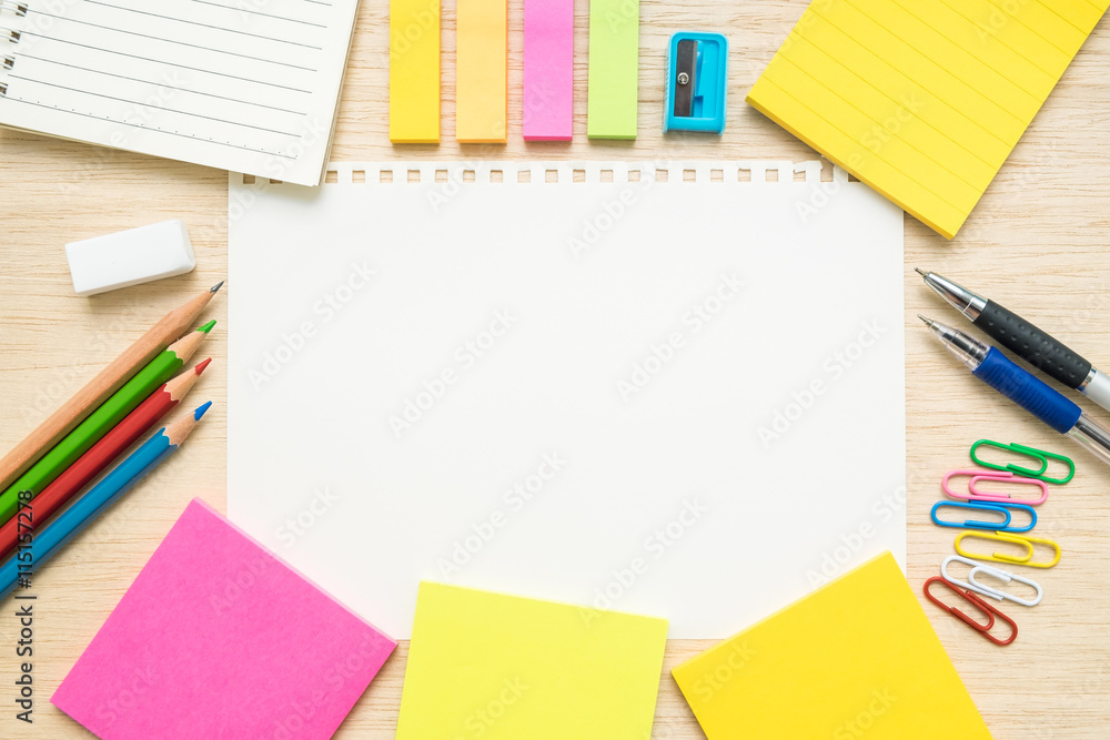 Table top view of stationery items with empty line paper on woo Table top view of stationery items with empty line paper on woo