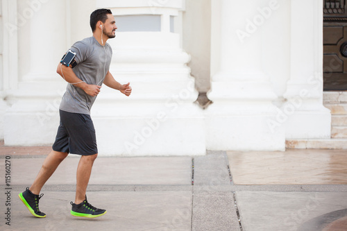 Man running and listening to music outdoors