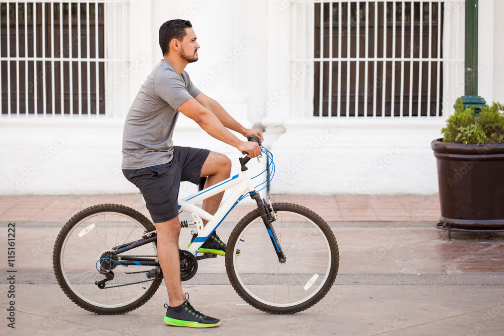 Young man riding a bicycle in the city Young man riding a bicycle in the city