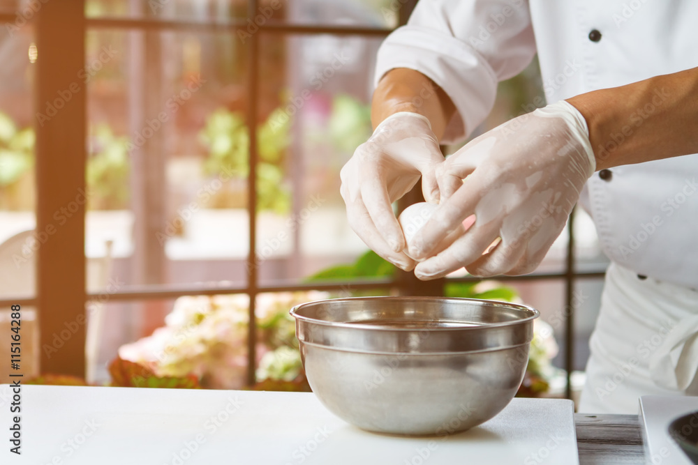 Man's hand holding an egg. White chicken egg. Chef starts preparing omelet. Only clean products. Man's hand holding an egg. White chicken egg. Chef starts preparing omelet. Only clean products.