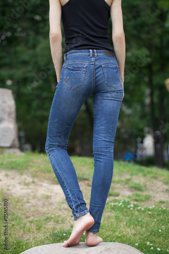 Back view of a long women legs posing with jeans © Andrey_Arkusha
