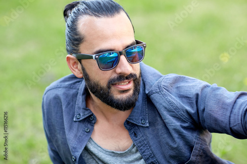 man in sunglasses at city street or park