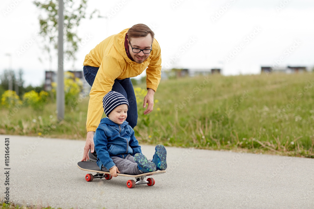 happy father and little son riding on skateboard happy father and little son riding on skateboard