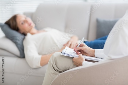 Obraz na plátně Therapist writing notes of patient