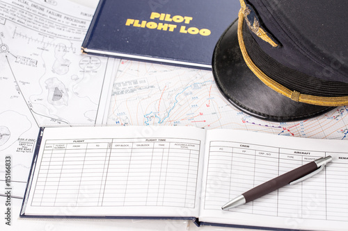 Close up of an airplane pilot equipment including flight log,hat
