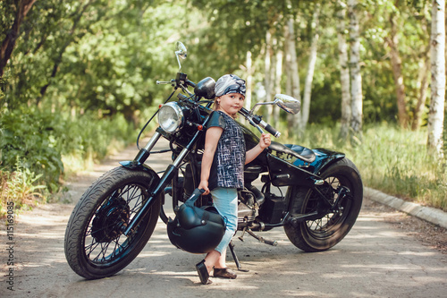 Little girl on a motorcycle.