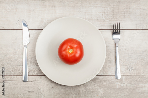 Tomato on Plate with wood Background
